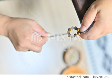Palo Santo Woman purifying a power stone with white sage Palo Santo Woman purifying a power stone with white sage 105701089