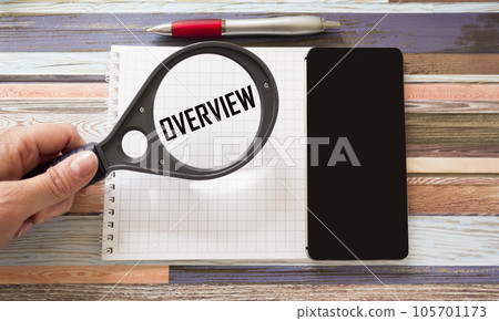 OVERVIEW, the text is written with a magnifying glass on a piece of paper. 105701173
