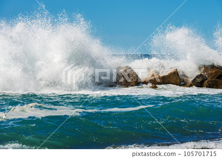 Breakwater in Liguria Italy - Large Waves of the Sea Break on the Rocks 105701715