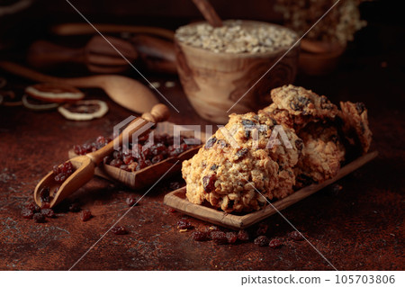 Oatmeal raisin cookies on a brown table. Oatmeal raisin cookies on a brown table. 105703806