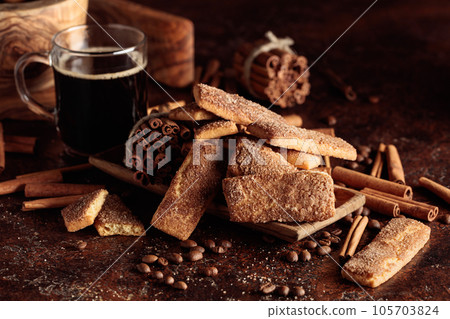 Sweet cinnamon cookies and a mug of black coffee. Sweet cinnamon cookies and a mug of black coffee. 105703824