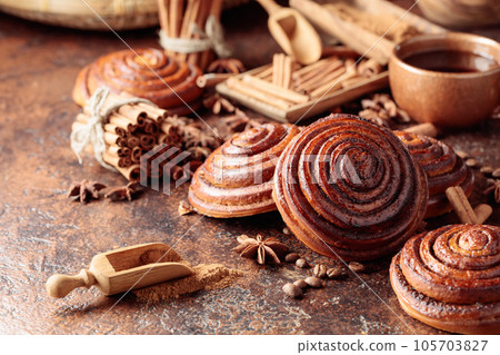 Freshly baked sweet cinnamon buns. Freshly baked sweet cinnamon buns. 105703827