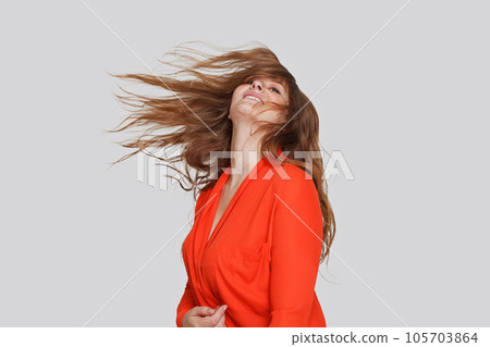 Beautiful woman with windy hair, studio portrait Beautiful woman with windy hair, studio portrait 105703864