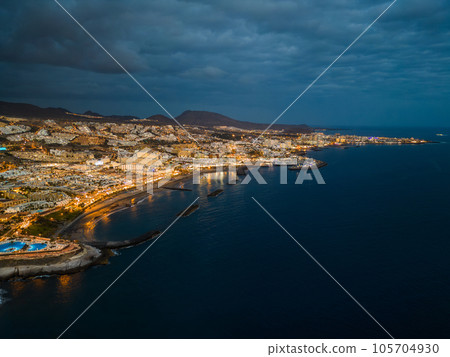 illuminated night city light view, ocean shore, Tenerife, Canary island aerial illuminated night city light view, ocean shore, Tenerife, Canary island aerial 105704930