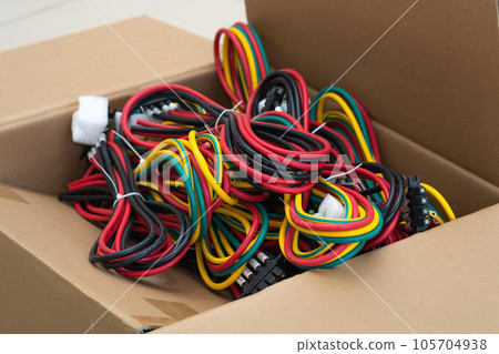sets of multi-colored cables with connectors in a packing box 105704938