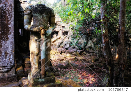 An ancient damaged statue near the Khmer ruins in Cambodia. 105706847