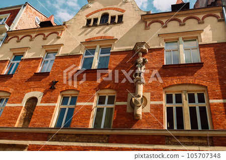 Typical old Poland buildings, low brick buildings across a narrow street, interesting old London architecture Typical old Poland buildings, low brick buildings across a narrow street, interesting old London architecture 105707348