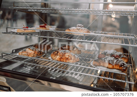 Assorted pastry and bread arranged on tray selling at bakery shop. 105707376