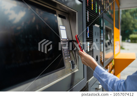 Woman client using automated self service post terminal machine or locker. Mail shipping concept 105707412