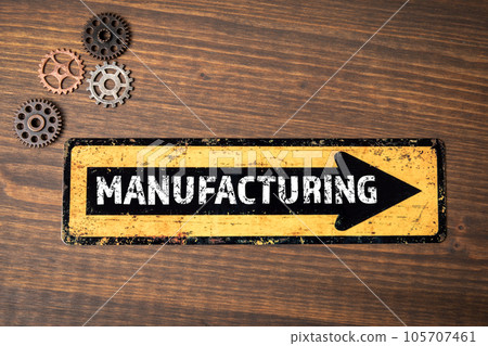 Manufacturing Concept. Direction arrow on wood texture background 105707461