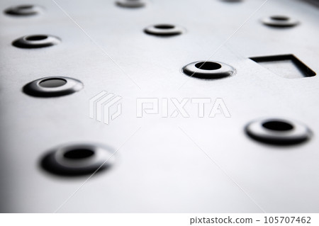 Galvanized metal plate surface with holes. Industrial style and constructions 105707462
