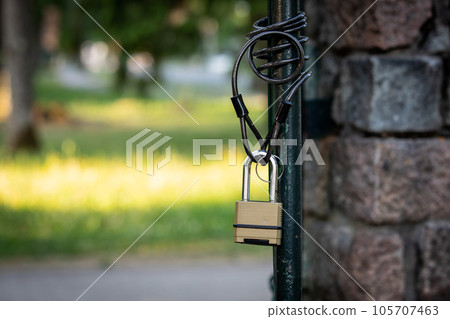 Open metal territory gate. Padlock with chain Open metal territory gate. Padlock with chain 105707463