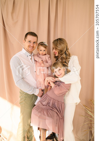 happy family of four father with mother and two daughters happy family of four father with mother and two daughters 105707554