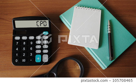 Calculator with CPD text on wooden background with notepad to write Calculator with CPD text on wooden background with notepad to write 105708465