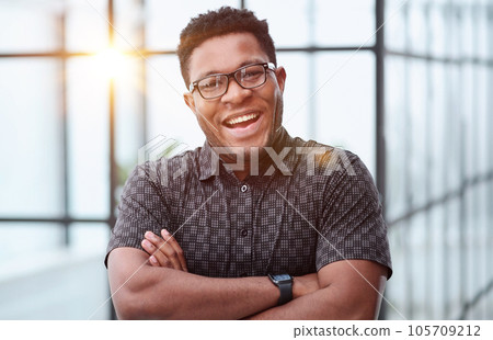 Portrait of happy African American small business owner posing with hands folded Portrait of happy African American small business owner posing with hands folded 105709212
