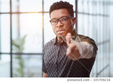 serious black businessman in glasses pointing at you 105709216