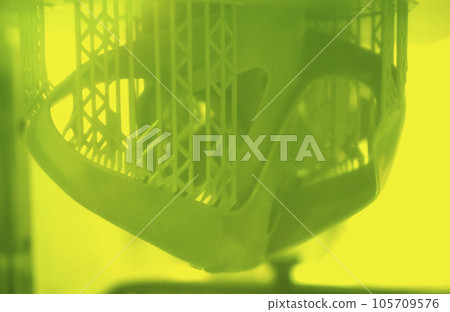 Printed models on 3D printer close-up. Objects printed on photopolymer sla 3D printer from liquid photopolymer resins on printing platform inside 3d printer. Modern progressive additive technology. 105709576