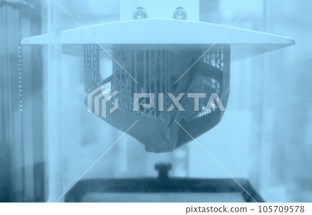 Printed models on 3D printer close-up. Objects printed on photopolymer sla 3D printer from liquid photopolymer resins on printing platform inside 3d printer. Modern progressive additive technology. 105709578