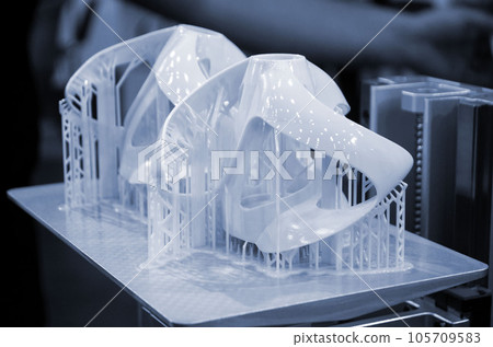 Printed models on 3D printer close-up. Objects printed on photopolymer sla 3D printer from liquid photopolymer resins on printing platform. Modern progressive additive technology. 3D printer printing 105709583