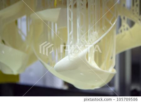 Printed models on 3D printer close-up. Objects printed on photopolymer sla 3D printer from liquid photopolymer resins on printing platform. Modern progressive additive technology. 3D printer printing 105709586