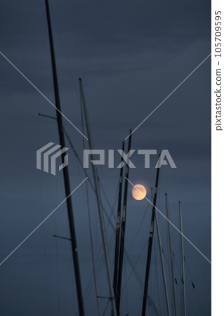 full moon across many match sailing boats at dusk full moon across many match sailing boats at dusk 105709595
