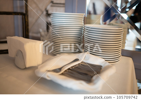 many clean white cups and plates on the table 105709742