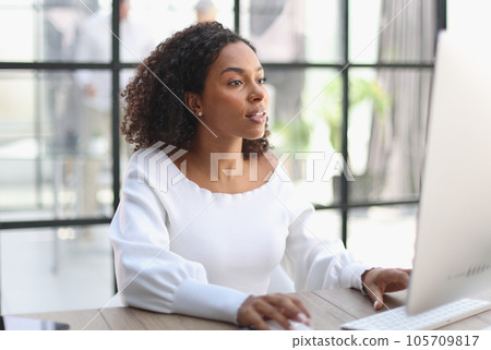 Happy african american woman using laptop work study in office Happy african american woman using laptop work study in office 105709817