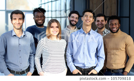 Businessmen posing in office lobby after meeting Businessmen posing in office lobby after meeting 105709818