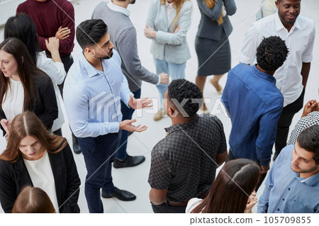 Coworkers having business meeting in a lobby 105709855