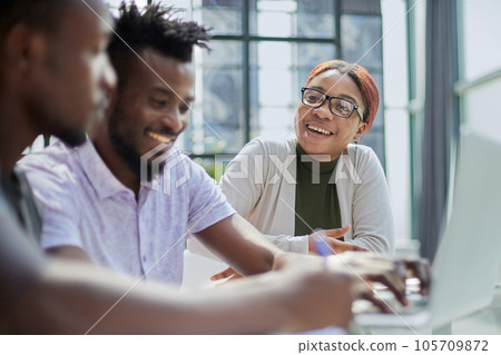 Successful african american business team talking about strategy at office Successful african american business team talking about strategy at office 105709872