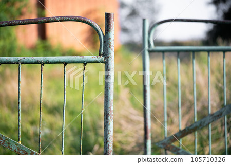 old rusty metal gate with cracked paint 105710326