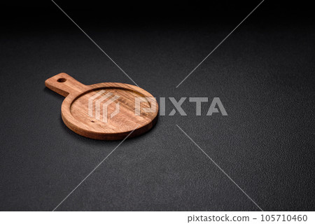 Empty round kitchen wooden cutting board in brown color 105710460