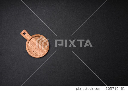 Empty round kitchen wooden cutting board in brown color 105710461