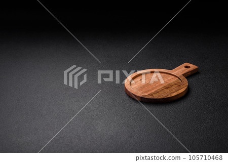 Empty round kitchen wooden cutting board in brown color 105710468