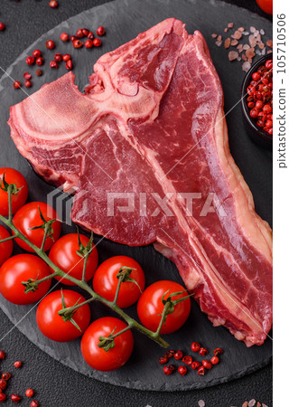 Raw fresh juicy beef t-bone steak with salt, spices and herbs Raw fresh juicy beef t-bone steak with salt, spices and herbs 105710506