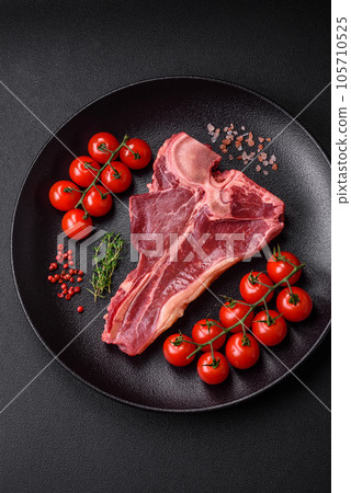 Raw fresh juicy beef t-bone steak with salt, spices and herbs Raw fresh juicy beef t-bone steak with salt, spices and herbs 105710525