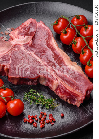 Raw fresh juicy beef t-bone steak with salt, spices and herbs Raw fresh juicy beef t-bone steak with salt, spices and herbs 105710530