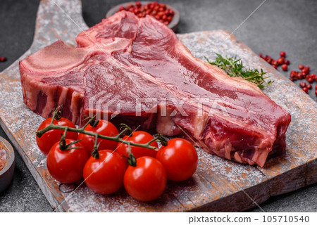 Raw fresh juicy beef t-bone steak with salt, spices and herbs Raw fresh juicy beef t-bone steak with salt, spices and herbs 105710540