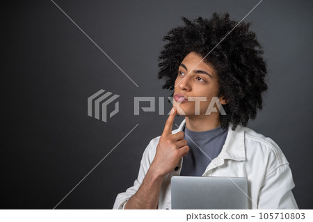 Young freelancer looking thoughtful and focused 105710803