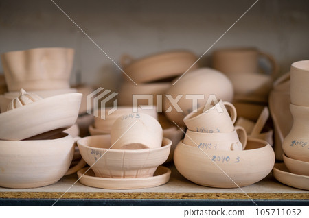 Pottery shelf in studio, creative store clay products, collection and display in workshop. Pottery shelf in studio, creative store clay products, collection and display in workshop. 105711052