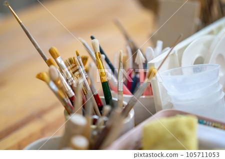 Pottery tools on wooden table in creative studio. 105711053