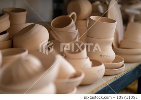 Pottery shelf in studio, creative store clay products, collection and display in workshop. Pottery shelf in studio, creative store clay products, collection and display in workshop. 105711055