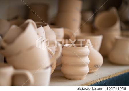 Pottery shelf in studio, creative store clay products, collection and display in workshop. Pottery shelf in studio, creative store clay products, collection and display in workshop. 105711056