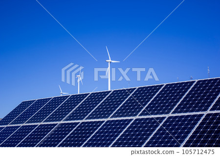 Solar panels and wind turbines with blue sky background Solar panels and wind turbines with blue sky background 105712475