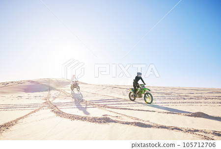Bike, sports and race with people in the desert for fitness or an adrenaline hobby for freedom. Motorcycle, training and summer with athlete friends riding a vehicle in Dubai for energy or balance 105712706