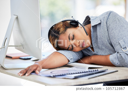 Tired, sleeping call center agent at the office in the afternoon. Exhausted young businesswomen resting on the desk in an office. Female feeling burnout taking a nap in the workplace. Tired, sleeping call center agent at the office in the afternoon. Exhausted young businesswomen resting on the desk in an office. Female feeling burnout taking a nap in the workplace. 105712867