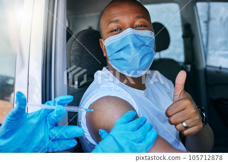 Drive thru covid and corona virus vaccine site as a public service for the people. Man giving thumbs up and endorsing the jab while wearing a mask to avoid infection, approving being vaccinated Drive thru covid and corona virus vaccine site as a public service for the people. Man giving thumbs up and endorsing the jab while wearing a mask to avoid infection, approving being vaccinated 105712878