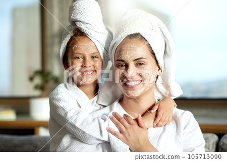 Facial, beauty and skincare at a spa for a bonding mother and daughter. Portrait of a cheerful, loving and joyful little girl enjoying a relaxing pamper session together with her mom or single parent Facial, beauty and skincare at a spa for a bonding mother and daughter. Portrait of a cheerful, loving and joyful little girl enjoying a relaxing pamper session together with her mom or single parent 105713090