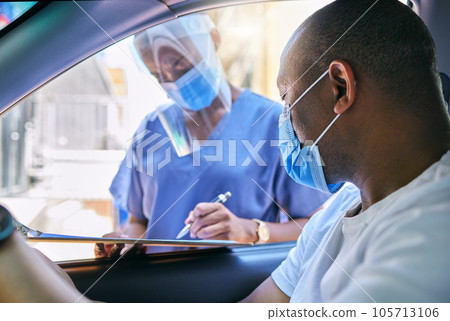 Covid testing centre and drive thru service for patients with coronavirus or getting vaccine. African man in car wearing a protective face mask to avoid contact with medical worker asking questions Covid testing centre and drive thru service for patients with coronavirus or getting vaccine. African man in car wearing a protective face mask to avoid contact with medical worker asking questions 105713106