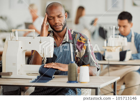 Stressed, tired male designer in pain from a stress headache while working. A overworked creative worker with a deadline feeling burnout. Portrait of a fashion design adult student feeling sick Stressed, tired male designer in pain from a stress headache while working. A overworked creative worker with a deadline feeling burnout. Portrait of a fashion design adult student feeling sick 105713146